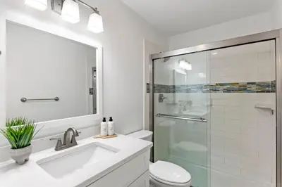 a bathroom with a sink and a glass shower at Beach Condo with Heated POOL and Tennis Courts and Beach Access and 6 Beds that Sleep 8 in Santa Rosa Beach