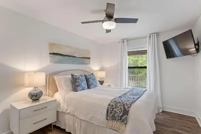 a white bedroom with a bed and a ceiling fan at Beach Condo with Heated POOL and Tennis Courts and Beach Access and 6 Beds that Sleep 8 in Santa Rosa Beach
