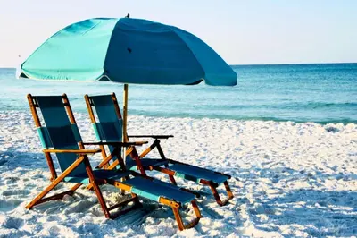 two chairs and an umbrella on the beach at Beach Condo with Heated POOL and Tennis Courts and Beach Access and 6 Beds that Sleep 8 in Santa Rosa Beach
