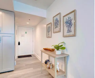 a hallway with a table with a plant on it at Sunbird Resort! Stunning Remodeled Beachfront Condo! Free Beach Chair Service! by Dolce Vita PCB! in Panama City Beach