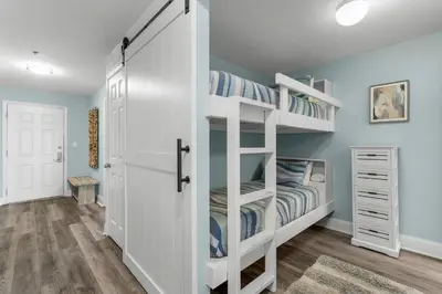 a bedroom with two bunk beds and a closet at Spectacular Ocean View Condo! Steps to the Beach! by Dolce Vita Getaways PCB! in Panama City Beach