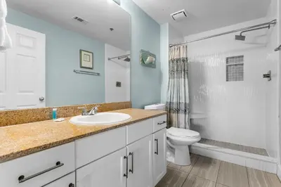 a bathroom with a sink and a toilet and a shower at Spectacular Ocean View Condo! Steps to the Beach! by Dolce Vita Getaways PCB! in Panama City Beach
