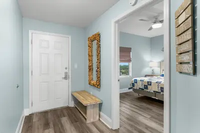 a hallway with a door leading to a bedroom at Spectacular Ocean View Condo! Steps to the Beach! by Dolce Vita Getaways PCB! in Panama City Beach