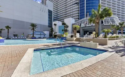 a swimming pool in the middle of a building at Spectacular Ocean View Condo! Steps to the Beach! by Dolce Vita Getaways PCB! in Panama City Beach