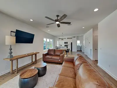 a living room with a couch and a table at Sunset On Snapper A in Panama City Beach