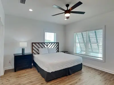 a bedroom with a bed and a ceiling fan at Sunset On Snapper B in Panama City Beach