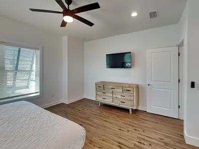 a bedroom with a bed and a ceiling fan at Sunset On Snapper B in Panama City Beach