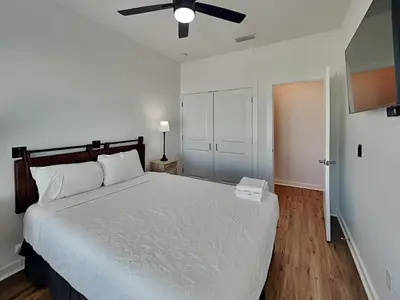 a bedroom with a bed and a ceiling fan at Sunset On Snapper B in Panama City Beach