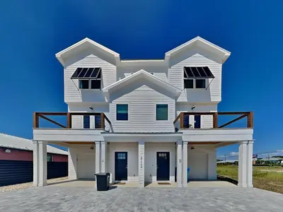 a white house with a blue sky in the background at Sunset On Snapper B in Panama City Beach