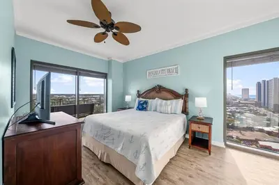a bedroom with a bed and a flat screen tv at Origin 1227 Beachy Dreams in Panama City Beach