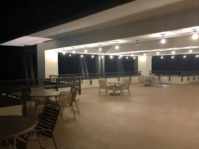 a large room with tables and chairs and lights at Origin 1227 Beachy Dreams in Panama City Beach