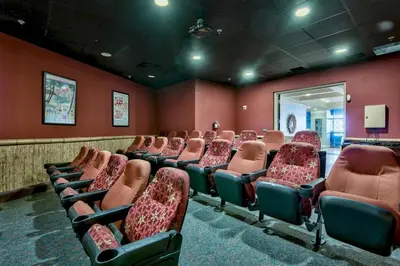 an empty room with red walls and chairs at Origin 1227 Beachy Dreams in Panama City Beach