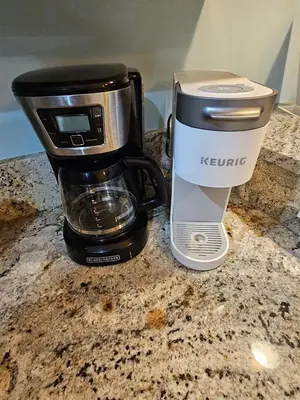 a coffee pot sitting on a counter with a coffee maker at Origin 1227 Beachy Dreams in Panama City Beach