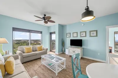 a living room with a couch and a table at Origin 1227 Beachy Dreams in Panama City Beach