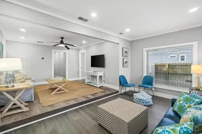 a living room with a couch and a tv at Beach House - Barefoot House by Panhandle Getaways in Panama City Beach