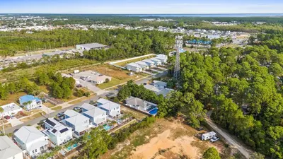 an aerial view of a building complex with trees at Beach House - Barefoot House by Panhandle Getaways in Panama City Beach