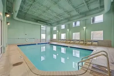 a large swimming pool in a large room at Stunning Beachfront 