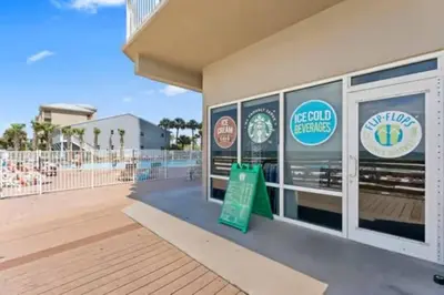 a building with a sign in front of a baseball field at Stunning Beachfront 