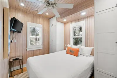 a bedroom with a bed and a ceiling fan at Carillon Beach House - Grits Carlton by Panhandle Getaways in Panama City Beach