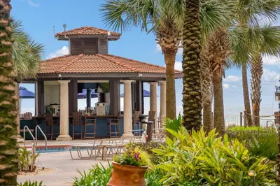 a house with a gazebo with palm trees at Shores Of Panama #0526 in Panama City Beach
