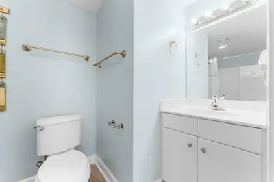 a white bathroom with a toilet and a sink at Shores Of Panama #0526 in Panama City Beach