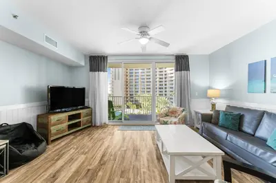 a living room with a couch and a tv at Shores Of Panama #0526 in Panama City Beach