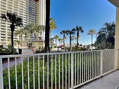 a balcony with a white fence and palm trees at Shores of Panama #109 in Panama City Beach