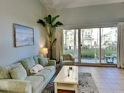 a living room with a couch and a table at Shores of Panama #109 in Panama City Beach