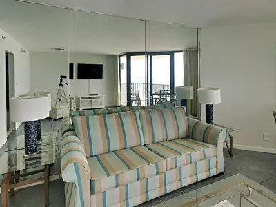 a living room with a couch and a television at Sunbird Beach Resort #604 East in Panama City Beach