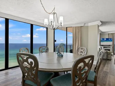 a dining room with a table and chairs and the ocean at Edgewater Tower III #1212 in Panama City Beach
