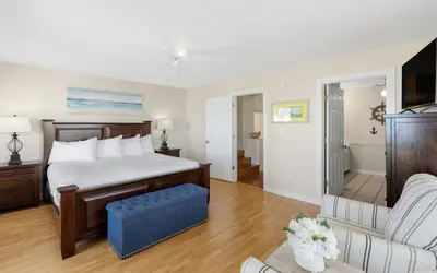 a bedroom with a bed and a living room at Seashell Castle by Oversee 30A in Santa Rosa Beach