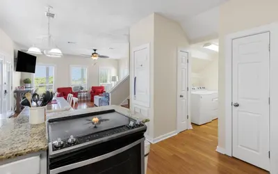 a kitchen and living room with a stove top oven at Seashell Castle by Oversee 30A in Santa Rosa Beach