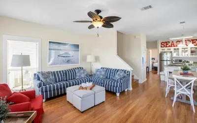a living room with two couches and a ceiling fan at Seashell Castle by Oversee 30A in Santa Rosa Beach