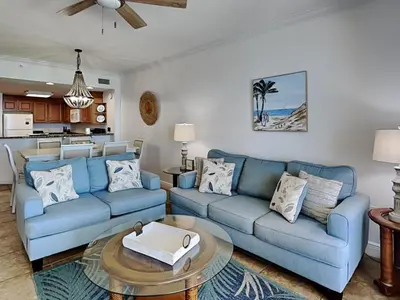 a living room with two blue couches and a table at Boardwalk #1008 in Panama City Beach