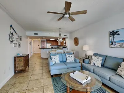 a living room with blue couches and a ceiling fan at Boardwalk #1008 in Panama City Beach