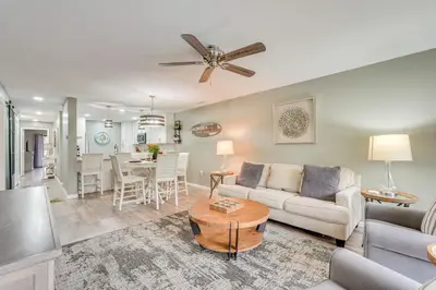 a living room with a couch and a table at Pool and Beach Trolley Access PCB Resort Condo! in Panama City Beach