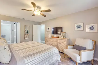 a bedroom with a bed and a ceiling fan at Pool and Beach Trolley Access PCB Resort Condo! in Panama City Beach
