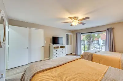 a bedroom with two beds and a ceiling fan at Pool and Beach Trolley Access PCB Resort Condo! in Panama City Beach