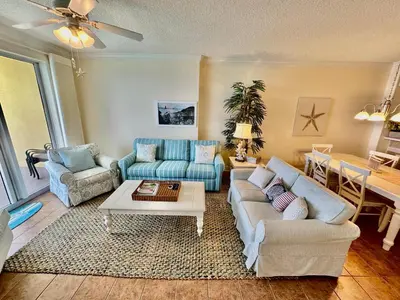 a living room with two couches and a table at Tropic Winds 2001 in Panama City Beach