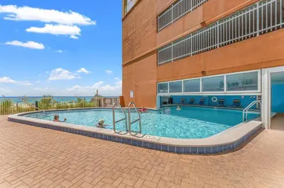 a swimming pool in front of a building at Tropic Winds 2001 in Panama City Beach