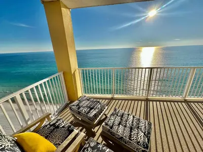 a balcony with chairs and a view of the ocean at Tropic Winds 2001 in Panama City Beach
