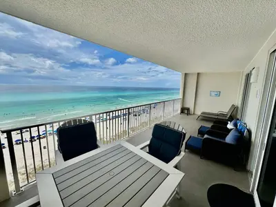 a balcony with chairs and a view of the ocean at Ocean Reef 804 in Panama City Beach