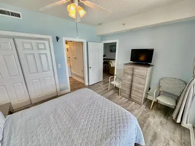 a bedroom with a bed and a flat screen tv at Ocean Reef 804 in Panama City Beach
