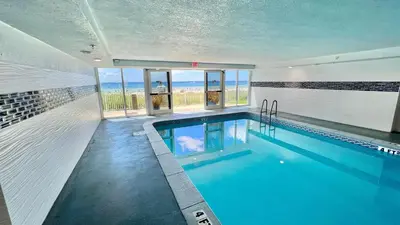 a swimming pool with a view of the ocean at Ocean Reef 804 in Panama City Beach