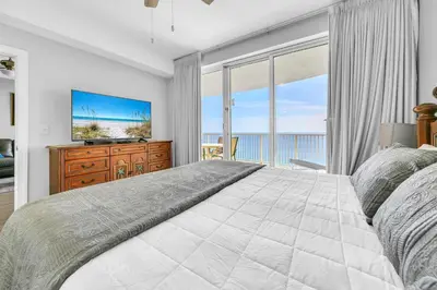 a bedroom with a large bed and a television at Emerald Isle 2305 in Panama City Beach