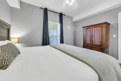 a bedroom with a large white bed and a window at Emerald Isle 2305 in Panama City Beach
