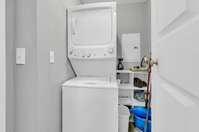 a white washer and dryer in a white room at Emerald Isle 2305 in Panama City Beach