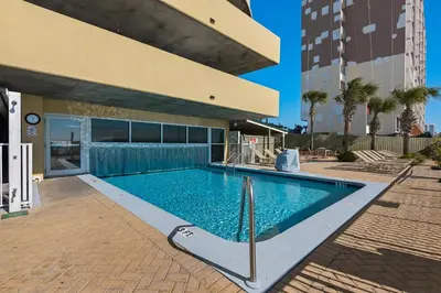 a swimming pool in front of a building at Emerald Isle 2305 in Panama City Beach