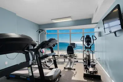 a room with a gym with a view of the ocean at Emerald Isle 2305 in Panama City Beach