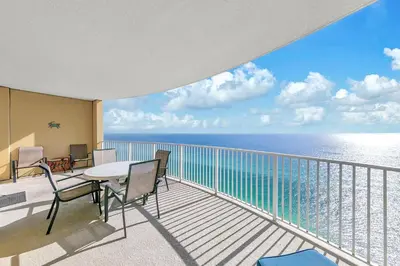 a balcony with a table and chairs and the ocean at Emerald Isle 2305 in Panama City Beach